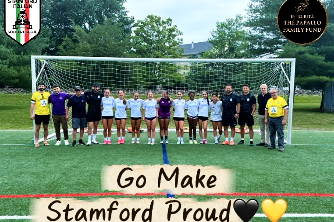 The Stamford FC 2013 Girls team with coaches and TPFF supporters at the goal