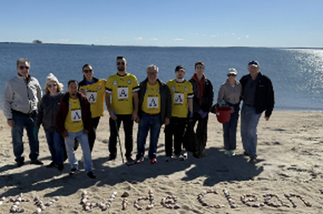 TPFF volunteers in yellow jerseys at the Stamford West Beach cleanup